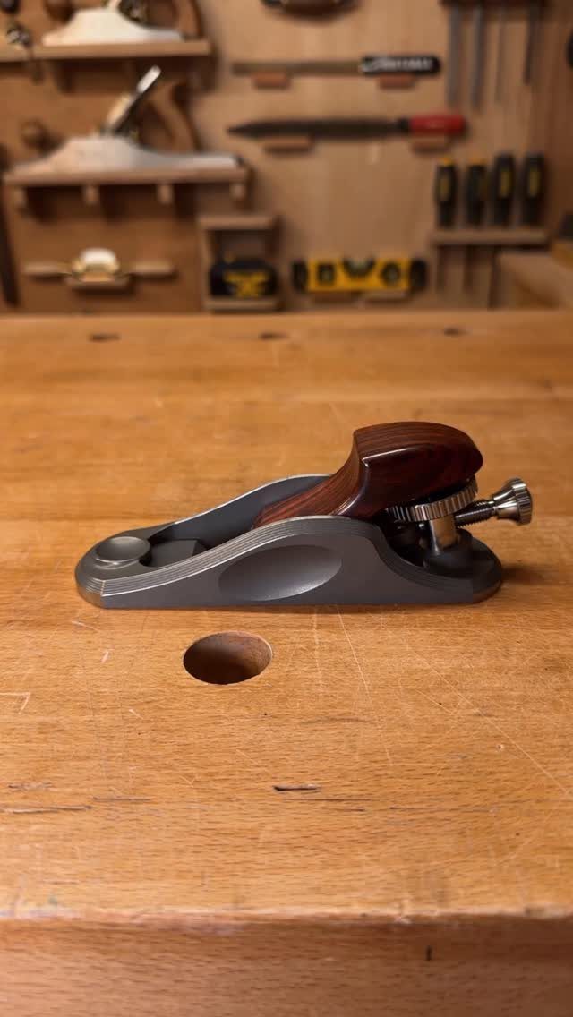 13 Carpentry Tools and Equipment for Every Workshop 3 Block plane with wooden handle sitting on a wooden carpenter's workbench