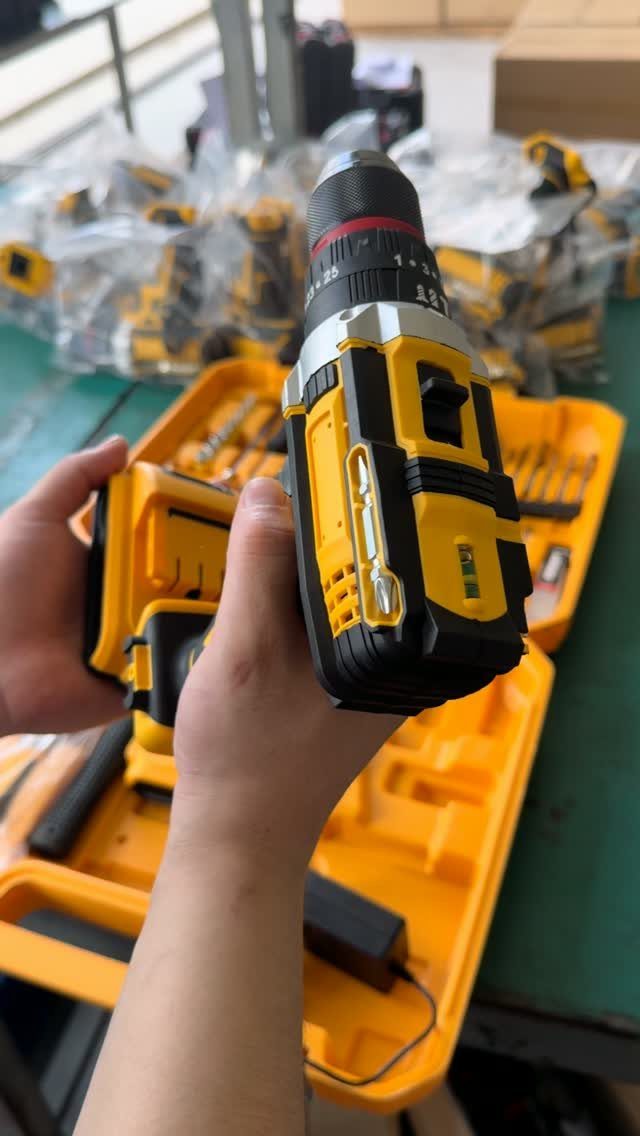 13 Carpentry Tools and Equipment for Every Workshop 10 Yellow and black cordless power drill held over an open tool kit case.