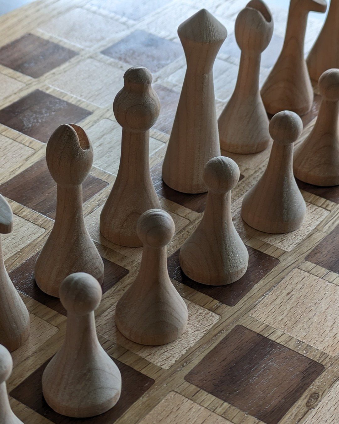 Cherry Wood Projects: 9 Ideas for Bowls, Boxes and More 2 Wooden game pieces standing on a checkered wooden game board