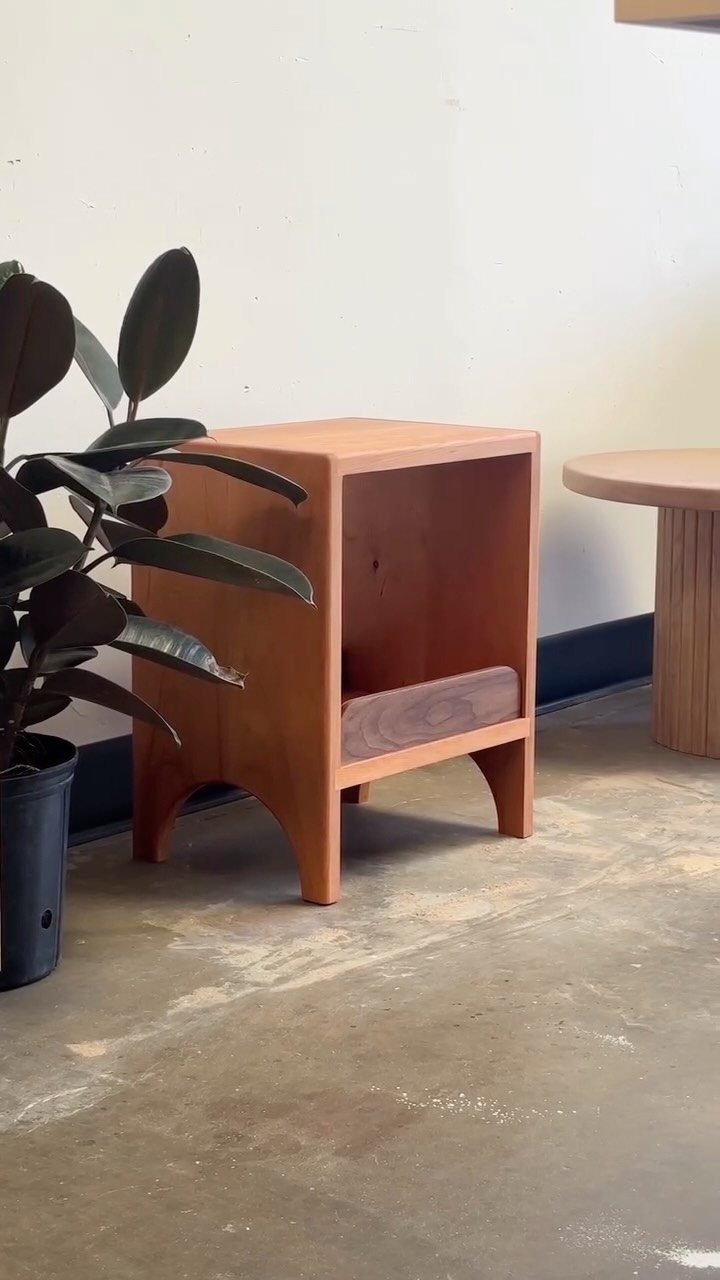 Cherry Wood Projects: 9 Ideas for Bowls, Boxes and More 9 Cherry wood side table with arched legs and open shelf next to a plant.