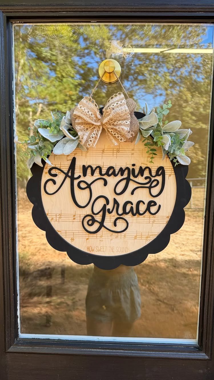 Christian Woodworking Projects: 9 Ideas for Home and Gifts 3 Circular wooden Amazing Grace sign with musical notes, burlap bow, and green leaves.