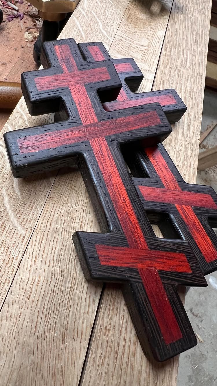 Christian Woodworking Projects: 9 Ideas for Home and Gifts 9 Three wooden Orthodox crosses with red and black inlays on a workbench.