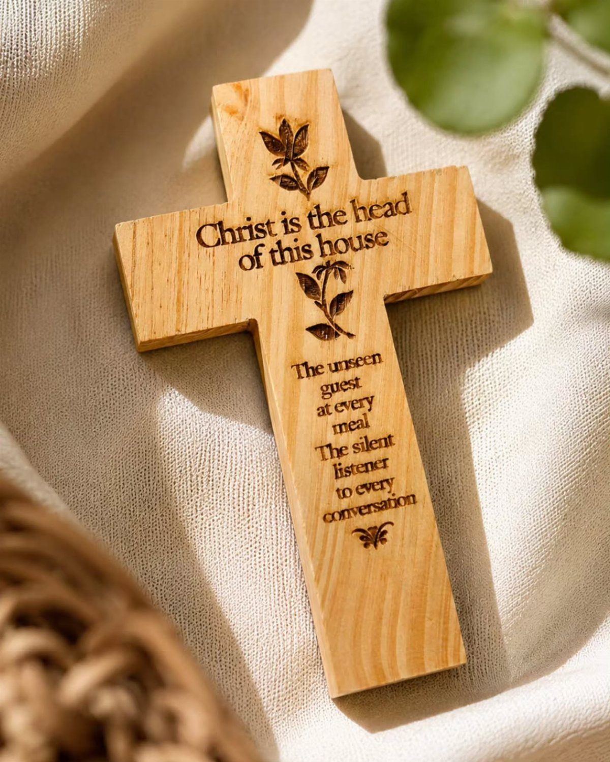 Christian Woodworking Projects: 9 Ideas for Home and Gifts 1 Wooden cross with engraved religious text resting on a soft cream fabric.