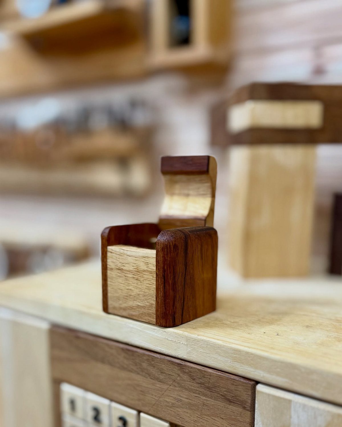 Creative Wood Designs: 8 Ideas for Furniture and Decor 8 Small handcrafted wooden box with contrasting light and dark wood on a workbench