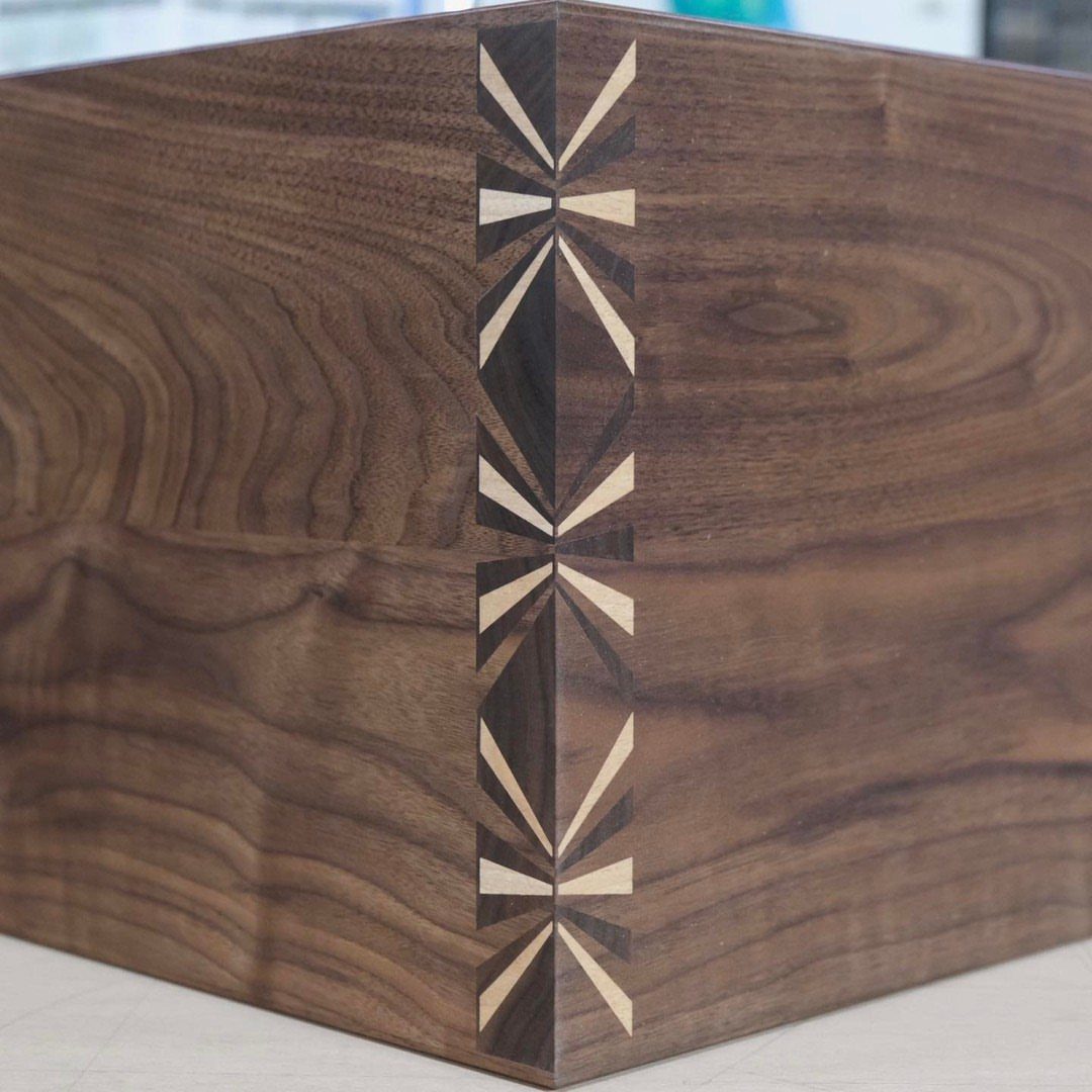 Creative Wood Designs: 8 Ideas for Furniture and Decor 2 Walnut wood box corner with intricate light-colored geometric wood inlay patterns.