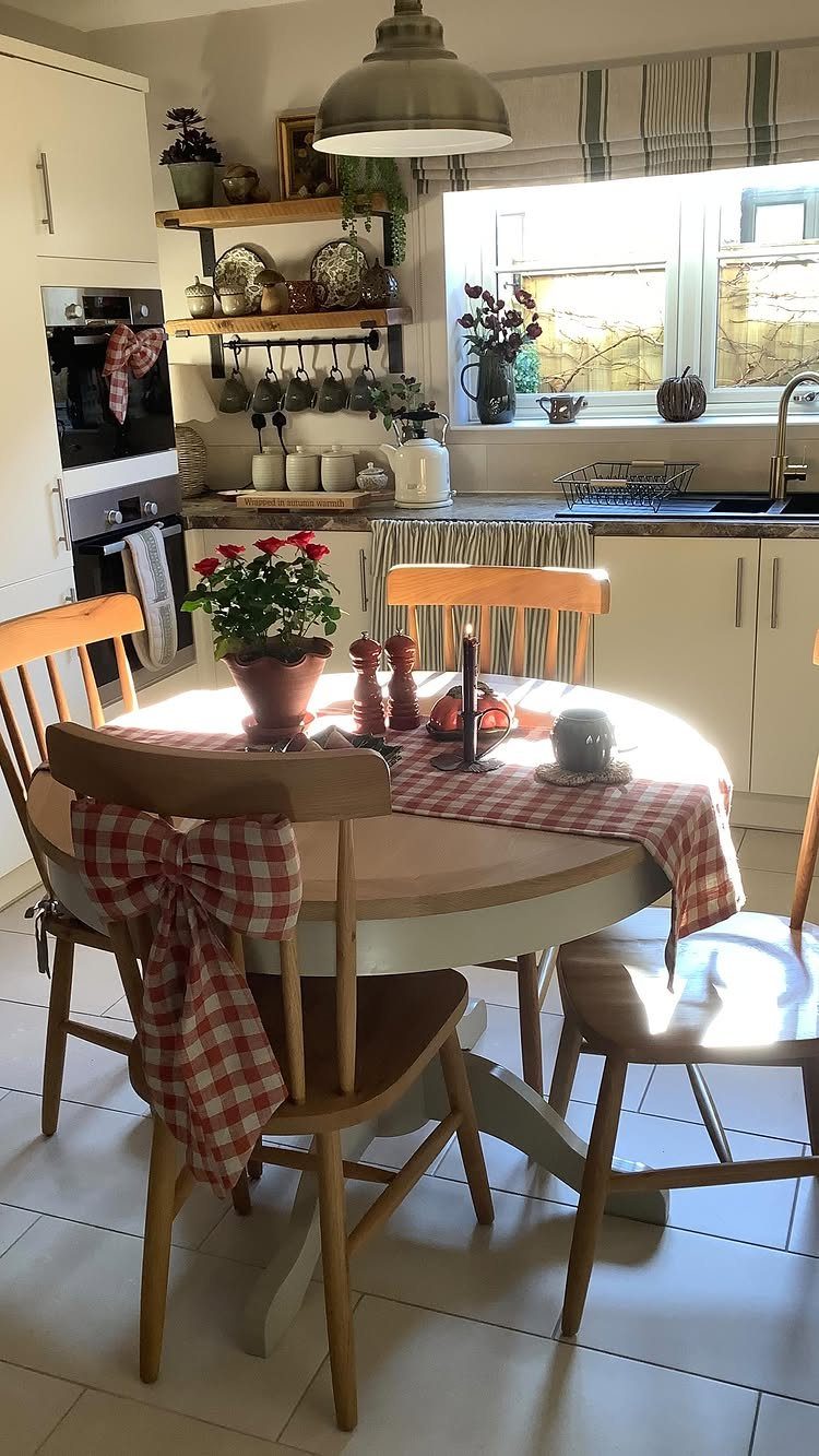 DIY Kitchen Chairs: 6 Ideas for Wood and Upholstery 4 Wooden kitchen chairs and round table with red checkered fabric accents in a kitchen.