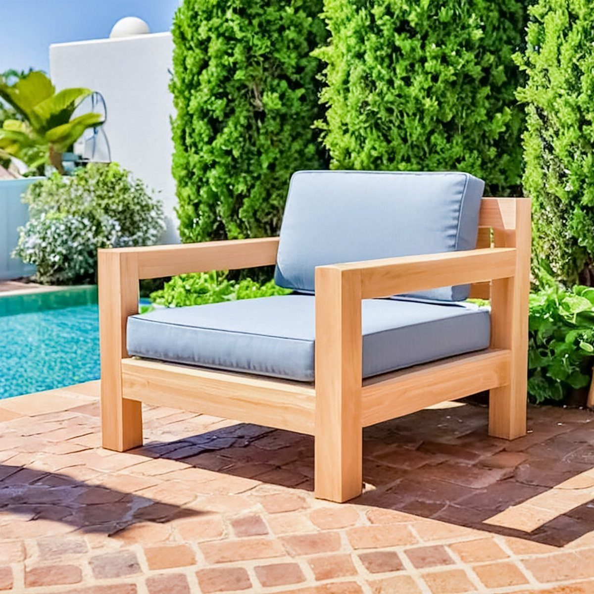 10 DIY Outdoor Chair Ideas for Patios, Porches and Decks 2 Wooden outdoor armchair with grey cushions on a brick patio by a pool
