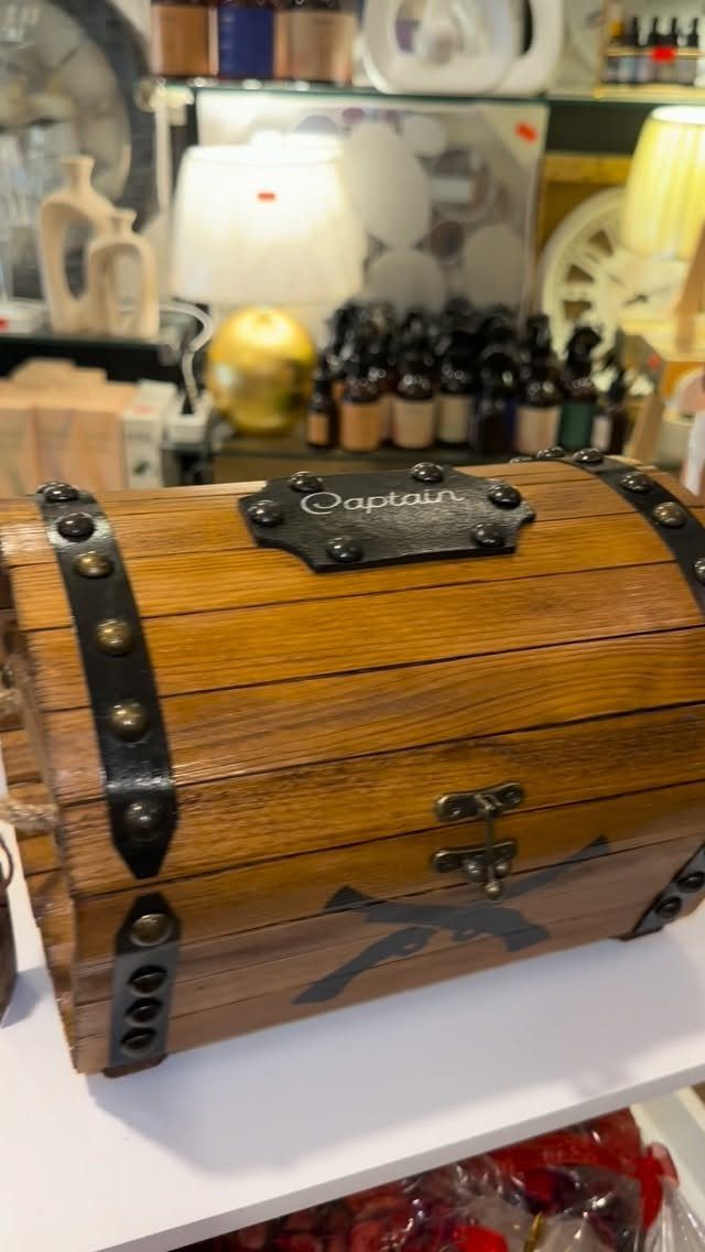 How to Build a DIY Treasure Chest With Wood: 12 Ideas 2 Wooden treasure chest with curved lid slats and black metal straps on white shelf
