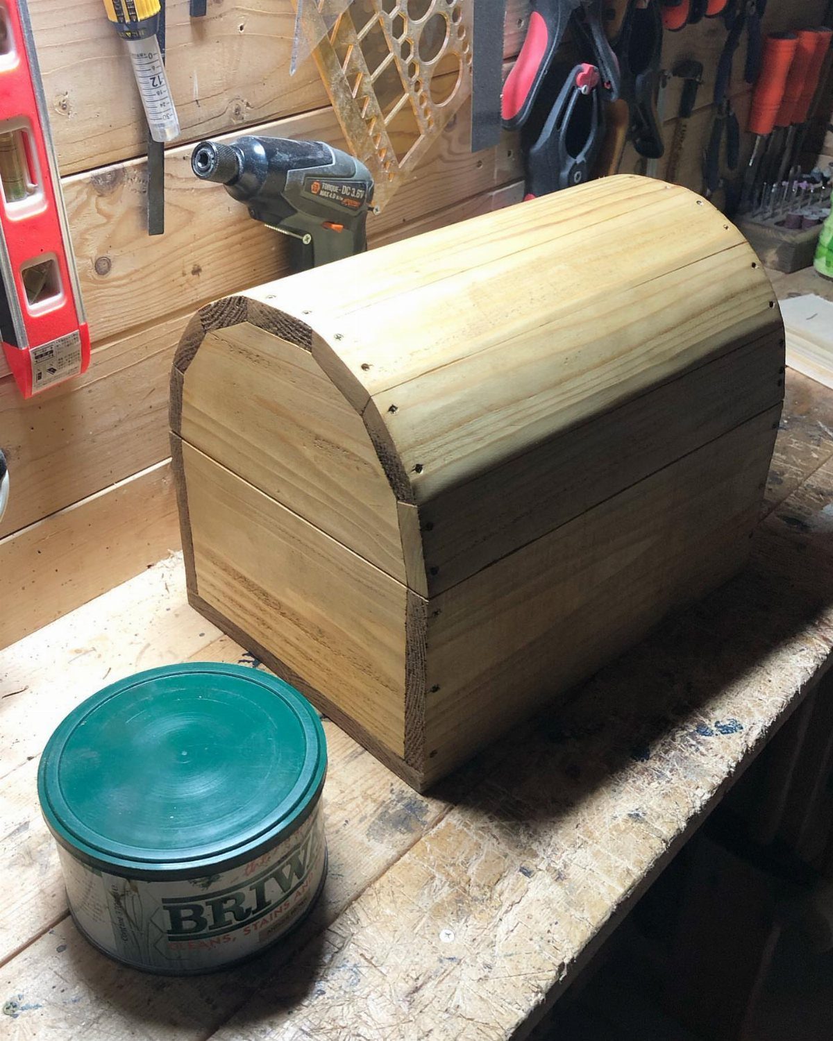 How to Build a DIY Treasure Chest With Wood: 12 Ideas 9 Wooden treasure chest with curved lid on a workbench in a tool workshop
