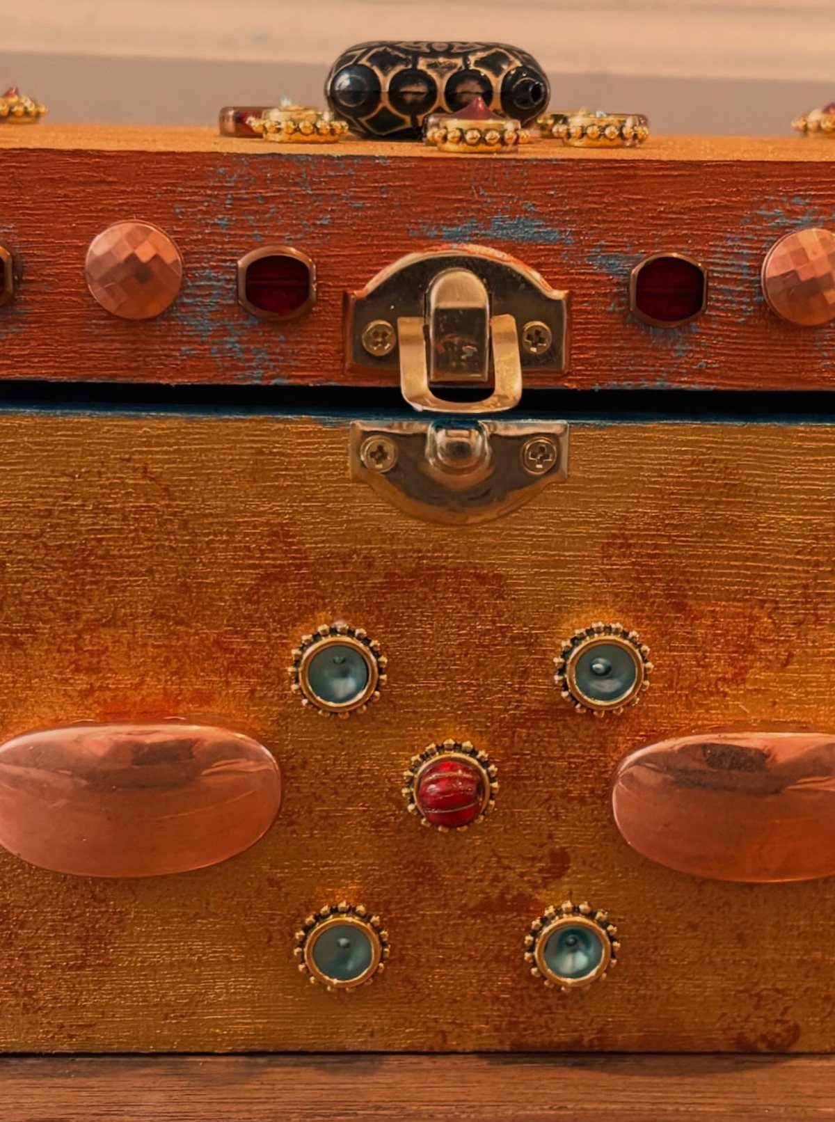 How to Build a DIY Treasure Chest With Wood: 12 Ideas 12 Wooden treasure chest with gold paint, metal latch, and colorful decorative gemstones.