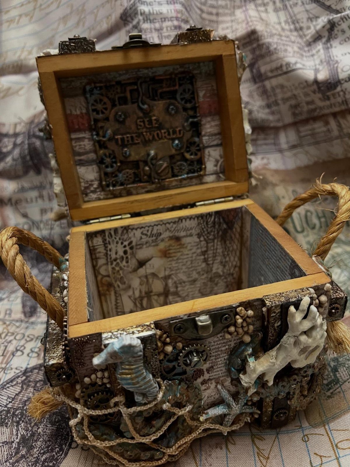 How to Build a DIY Treasure Chest With Wood: 12 Ideas 10 Handcrafted wooden treasure chest decorated with seashells, seahorses, and nautical netting.