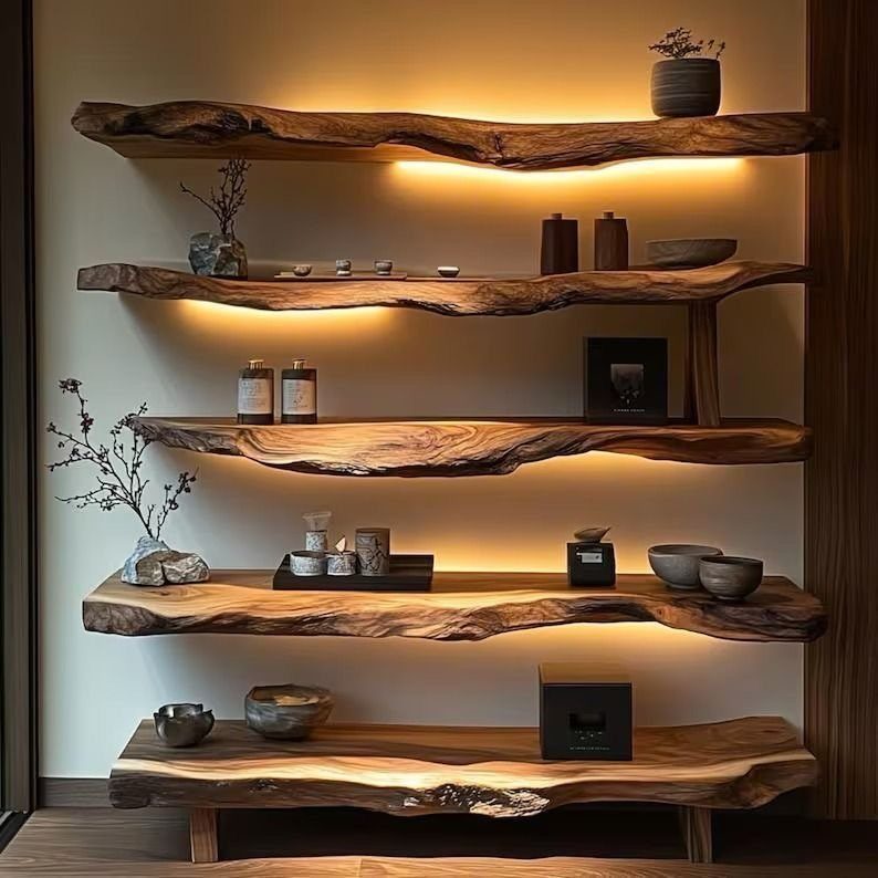 Live-edge wooden shelves with warm under-lighting holding various ceramic decorative items.