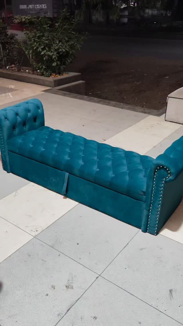 Teal blue tufted velvet bench with rolled arms and silver nailhead trim.