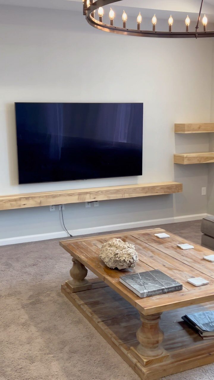 16 DIY Wooden Projects for Home, Garden, and Holiday Decor 2 Wooden floating shelves mounted on a wall below a television in a living room