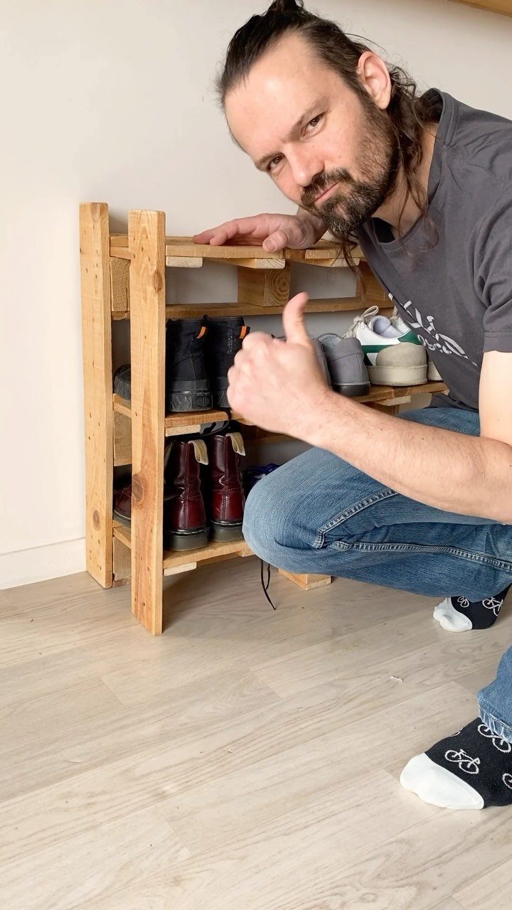 16 DIY Wooden Projects for Home, Garden, and Holiday Decor 11 Man giving thumbs up next to a handmade wooden shoe rack holding boots.