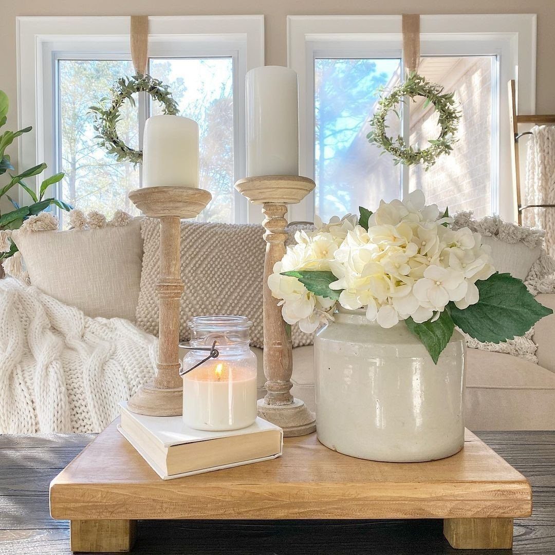 6 DIY Wooden Riser Ideas for Plants, Kitchens and Decor 1 Wooden riser platform holding white candles and a vase of white hydrangeas.
