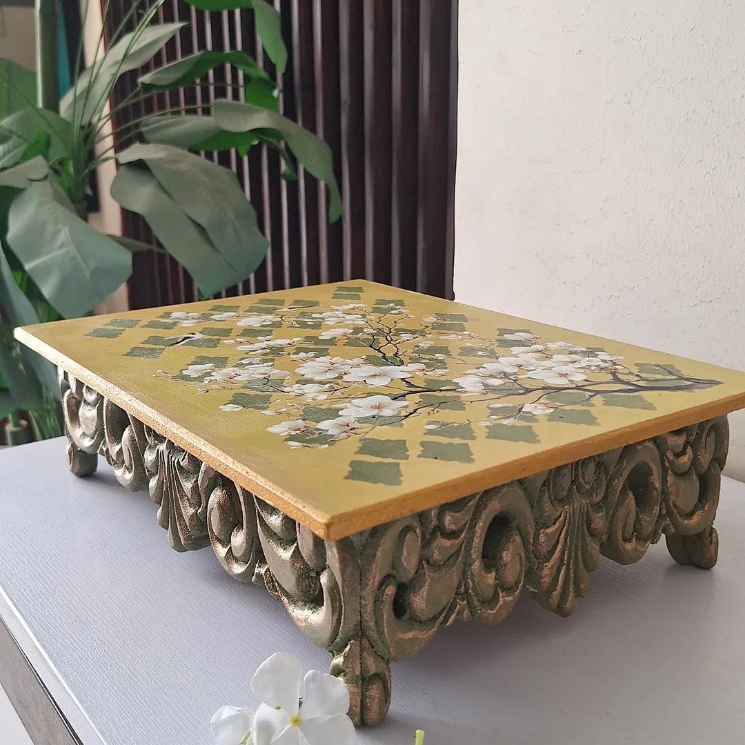 6 DIY Wooden Riser Ideas for Plants, Kitchens and Decor 2 Wooden riser with ornate gold base and hand-painted white blossoms on yellow top.