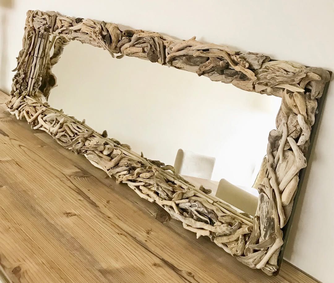 Rectangular mirror with a thick frame made of weathered light-colored driftwood pieces.