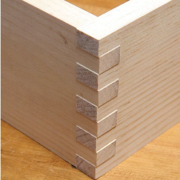 Finger Joints Woodworking: 4 Ideas for Strong Corners 1 Interlocking finger joints on the corner of a light-colored wooden box.
