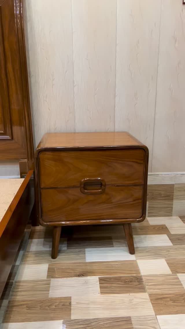Furniture Design with Wooden Details: 9 Ideas for Home 4 Polished brown wooden nightstand with two drawers and tapered legs against a wall.