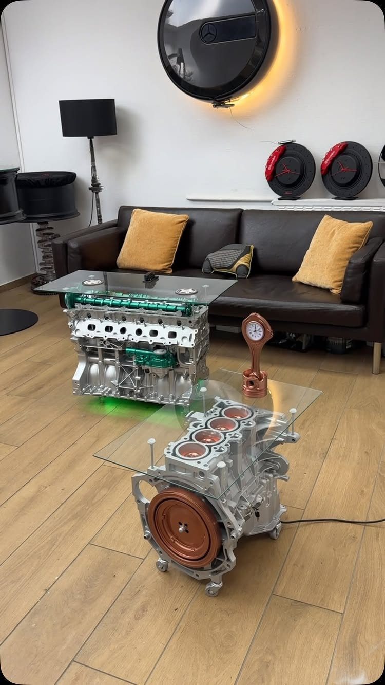 Car engine block coffee tables with glass tops in a modern living room
