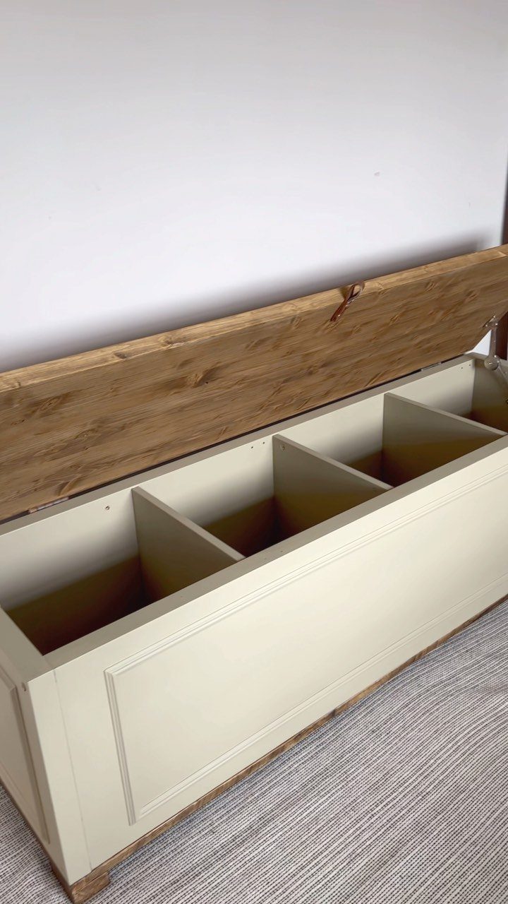 White painted wooden storage chest with an open natural wood lid and internal dividers.