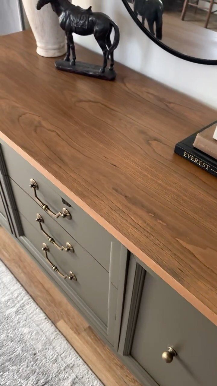 Vintage buffet with sage green painted base and natural wood top surface.