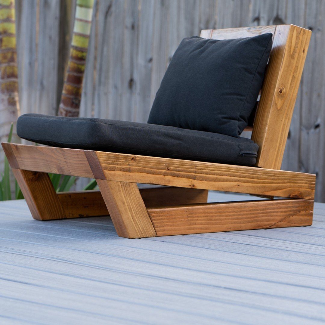 Furniture Plans Free for 16 Tables, Beds and Benches 2 Modern wooden outdoor lounge chair with black cushions on a grey deck.