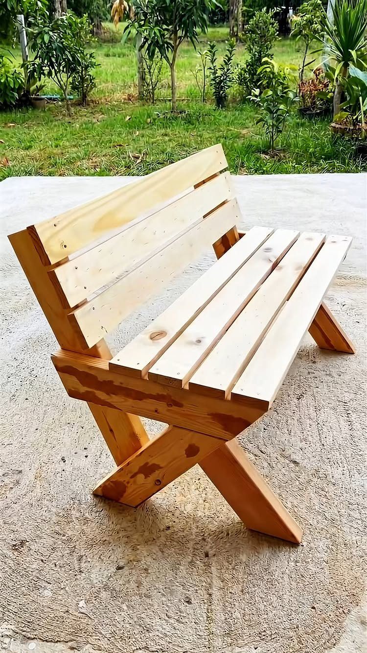 Furniture Plans Free for 16 Tables, Beds and Benches 6 Wooden outdoor bench with slatted seat and X-shaped legs on a concrete patio.