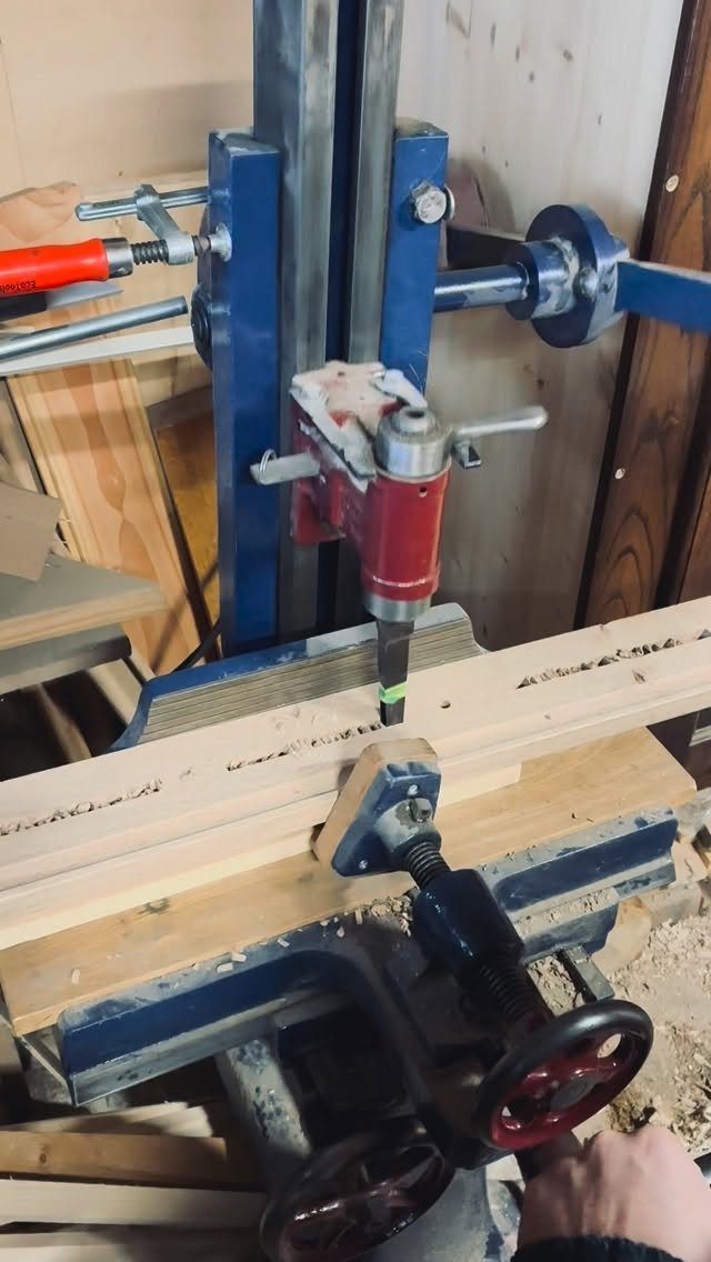 7 Homemade Tools for Woodworking You Can Build 5 Homemade woodworking tool with a red router mounted on a blue metal frame.