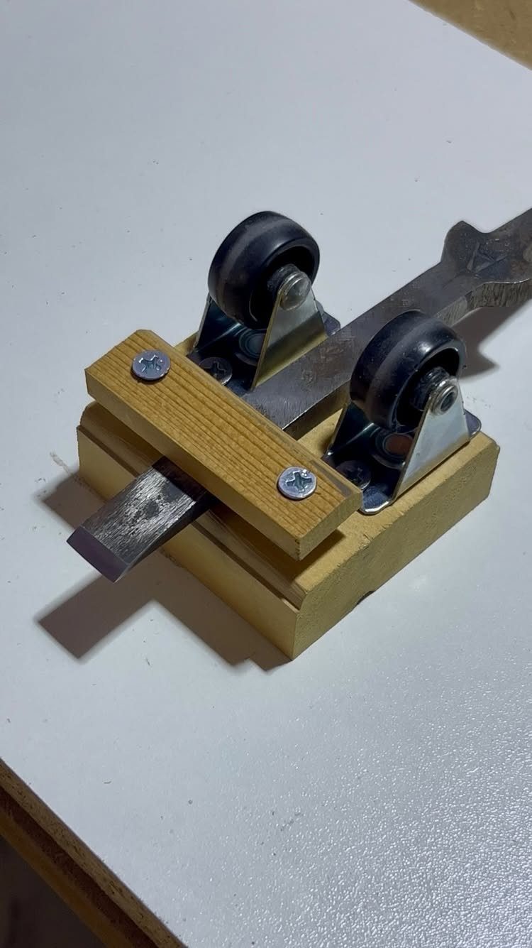 7 Homemade Tools for Woodworking You Can Build 3 Homemade woodworking tool with caster wheels and a metal blade on white surface
