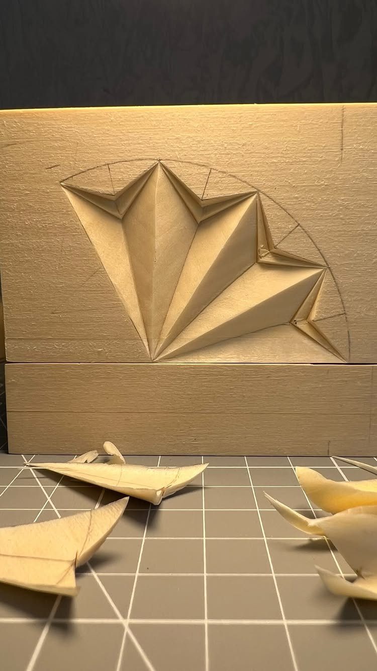 Intricate Wood Carving Ideas: 3 Styles to Try 1 Geometric chip carving design in a light wood block with wood shavings below.