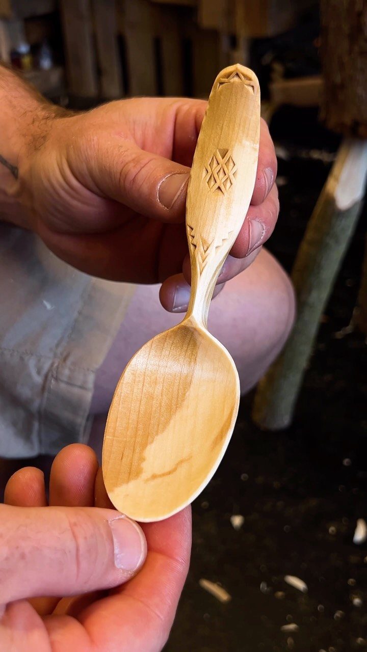 Intricate Wood Carving Ideas: 3 Styles to Try 2 Hand-carved wooden spoon with detailed geometric patterns on the handle held by hands.