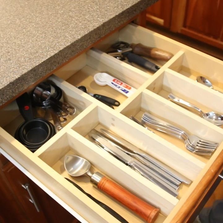 18 Kitchen Woodworking Projects for Storage and Gifts 1 Wooden kitchen drawer organizer with custom dividers holding various silver utensils and tools.