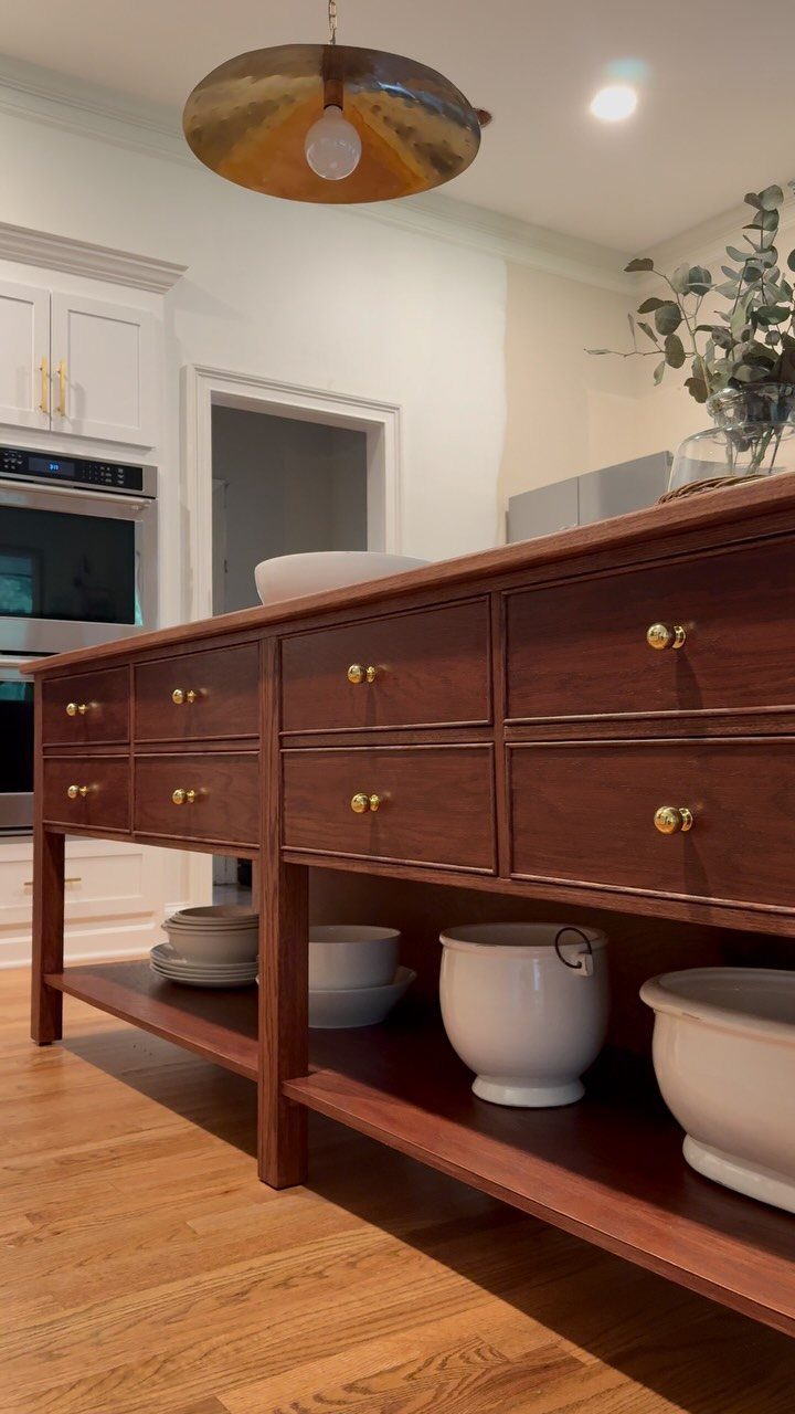 18 Kitchen Woodworking Projects for Storage and Gifts 6 Wooden kitchen island with drawers and open shelving holding white ceramic bowls