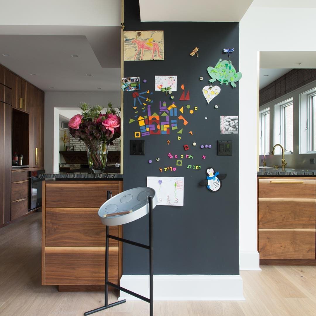 18 Kitchen Woodworking Projects for Storage and Gifts 13 Dark grey magnetic chalkboard wall with colorful children's art in a modern kitchen