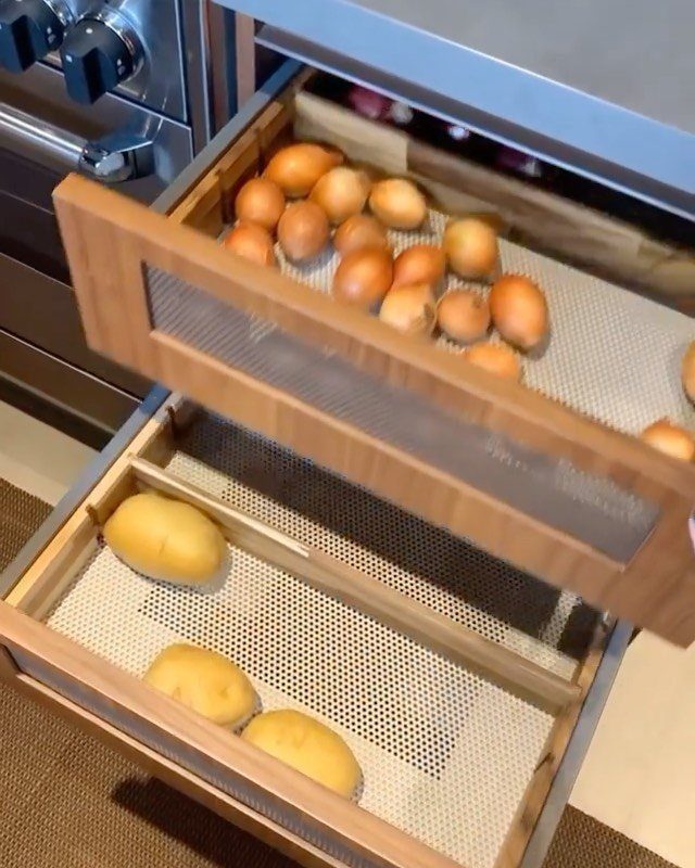 18 Kitchen Woodworking Projects for Storage and Gifts 8 Wooden pull-out drawers with perforated bottoms filled with potatoes under a kitchen counter