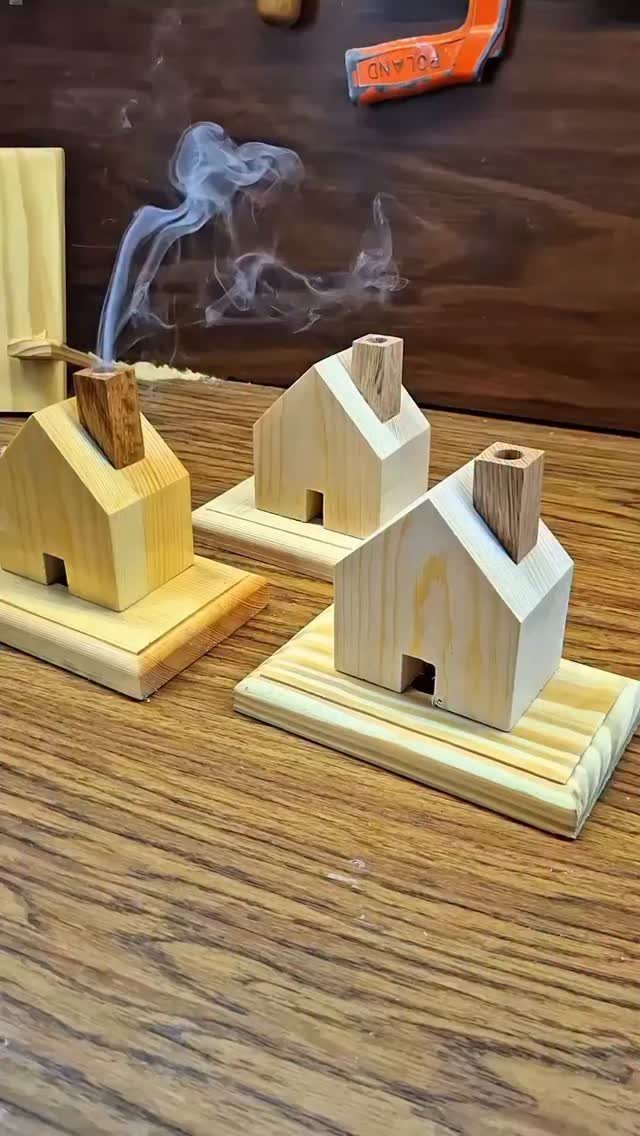 32 Mini Wood Projects for Beginners and Scrap Wood 29 Three small wooden house models with smoke rising from one chimney on a workbench