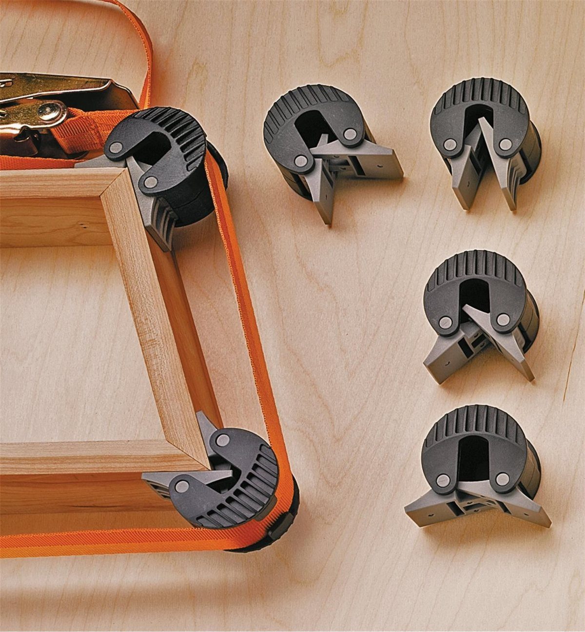 Mitered Corners for Wood: 4 Ideas for Tight Joints 3 Wooden picture frame held by a strap clamp with black plastic corner guides