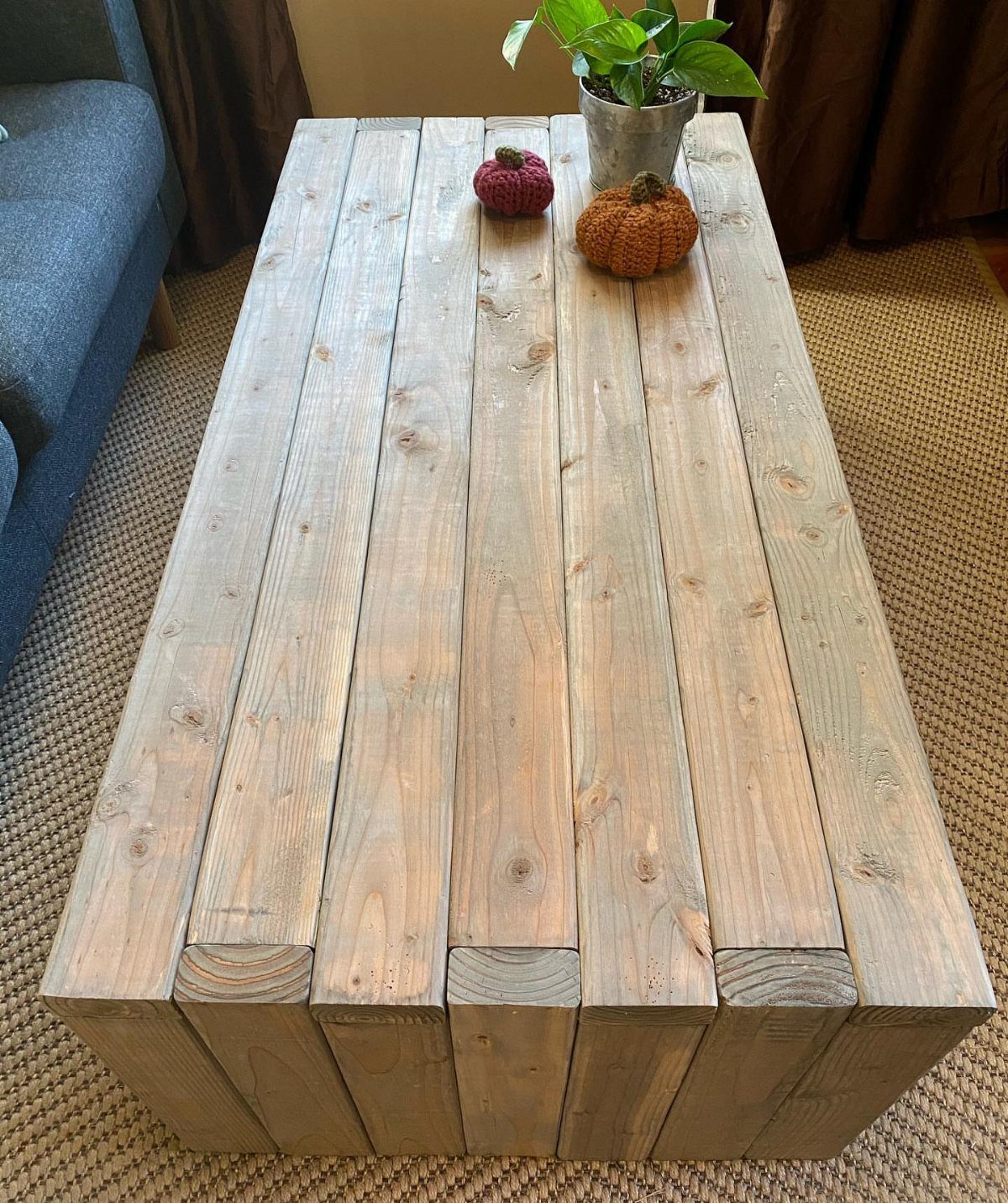 21 Pallet Wood DIY Projects for Home, Holidays and Yard 1 Rustic pallet wood coffee table with small decorative pumpkins and a potted plant