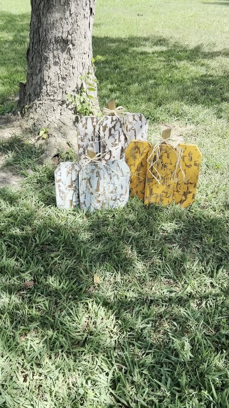 21 Pallet Wood DIY Projects for Home, Holidays and Yard 8 Wooden pallet pumpkins with twine bows sitting on green grass by a tree