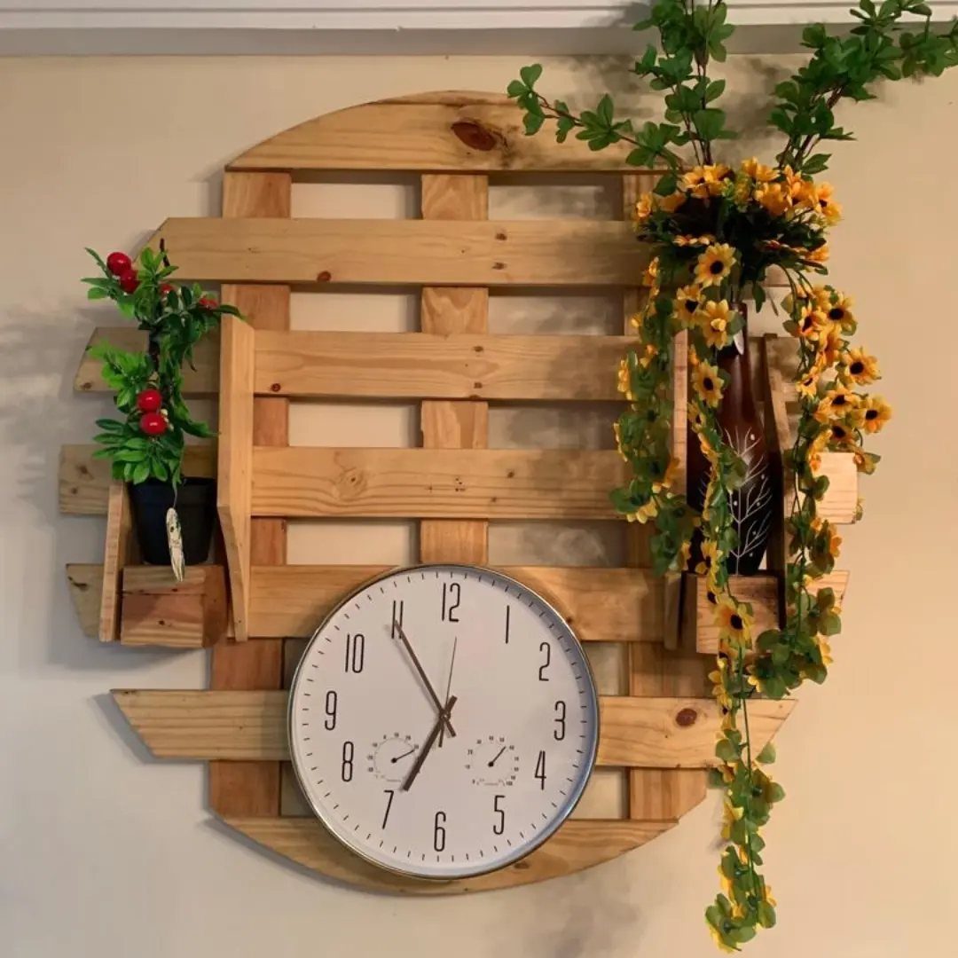 21 Pallet Wood DIY Projects for Home, Holidays and Yard 6 Round white analog clock mounted on a light-colored wooden pallet with floral accents.