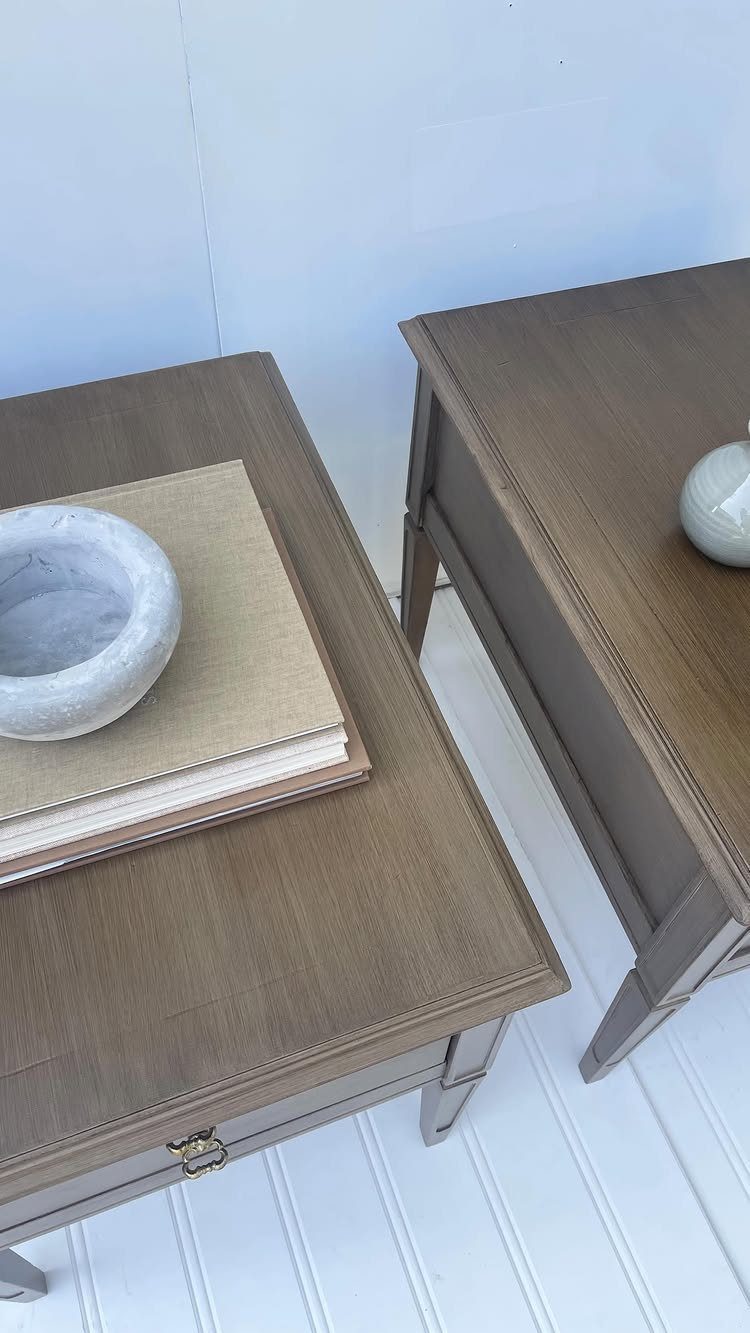 Brown-grey painted wooden side tables with a matte finish and a marble bowl.