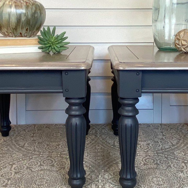 Two side tables with weathered wood tops and dark grey painted bases.
