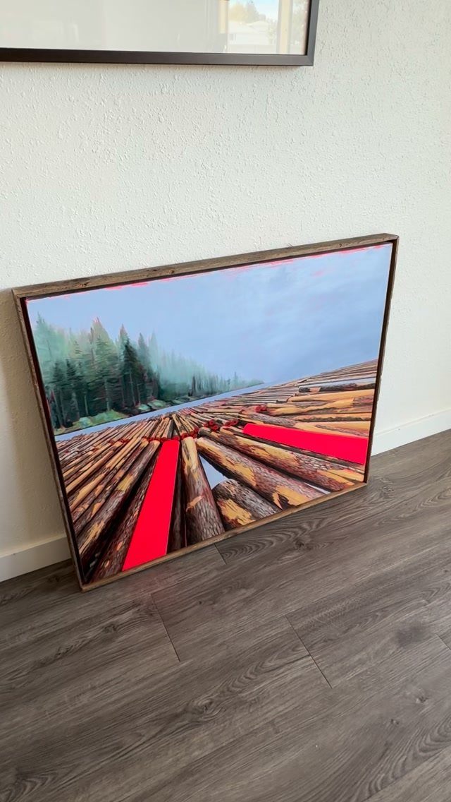 14 Reclaimed Wood Projects for Rustic Home Decor 6 Wooden picture frame holding a painting of logs leaning against a white wall