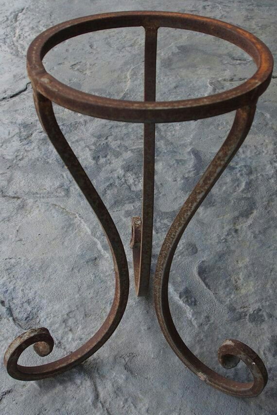 Rustic Plant Stand Ideas: 5 Styles for Any Room 4 Wrought iron plant stand with a circular top and curved scroll legs.