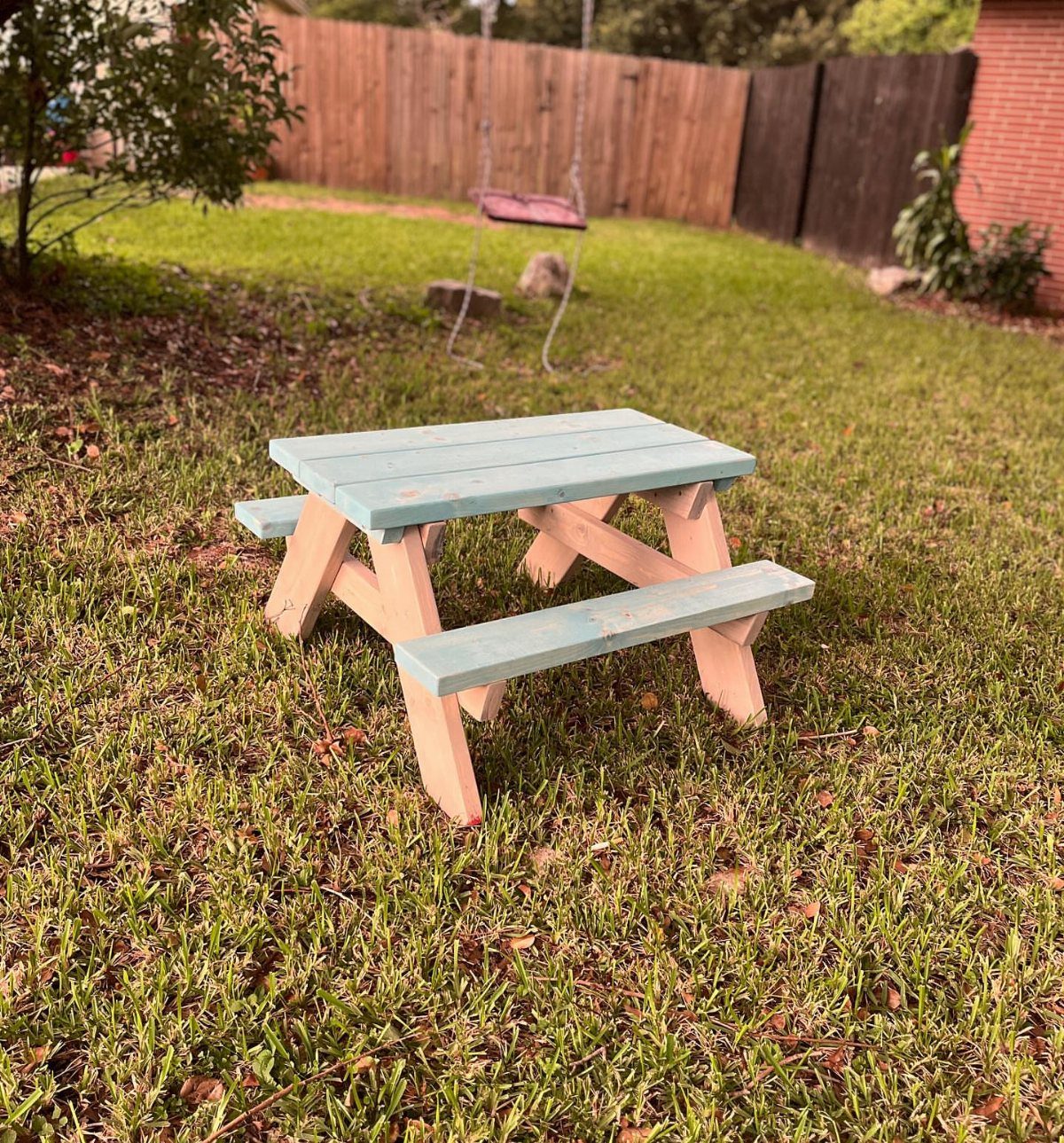 13 Scrap Wood Art Ideas for Using Up Your Leftover Boards 6 Small child-sized picnic table with blue top and benches on a grassy lawn.