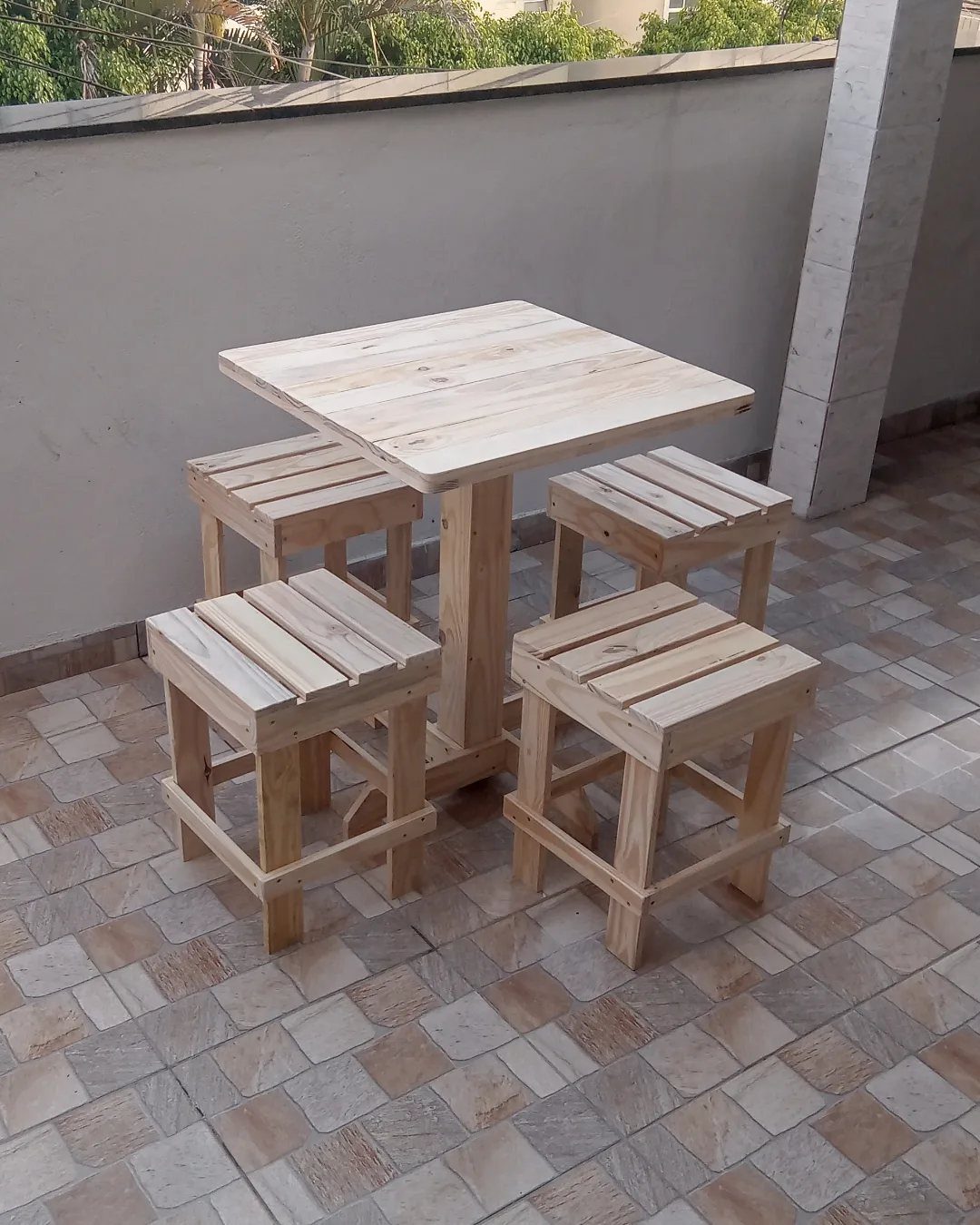 13 Small Wood Craft Ideas for Beginners and Scrap Wood 9 Small square wooden table with four matching stools on a tiled balcony.