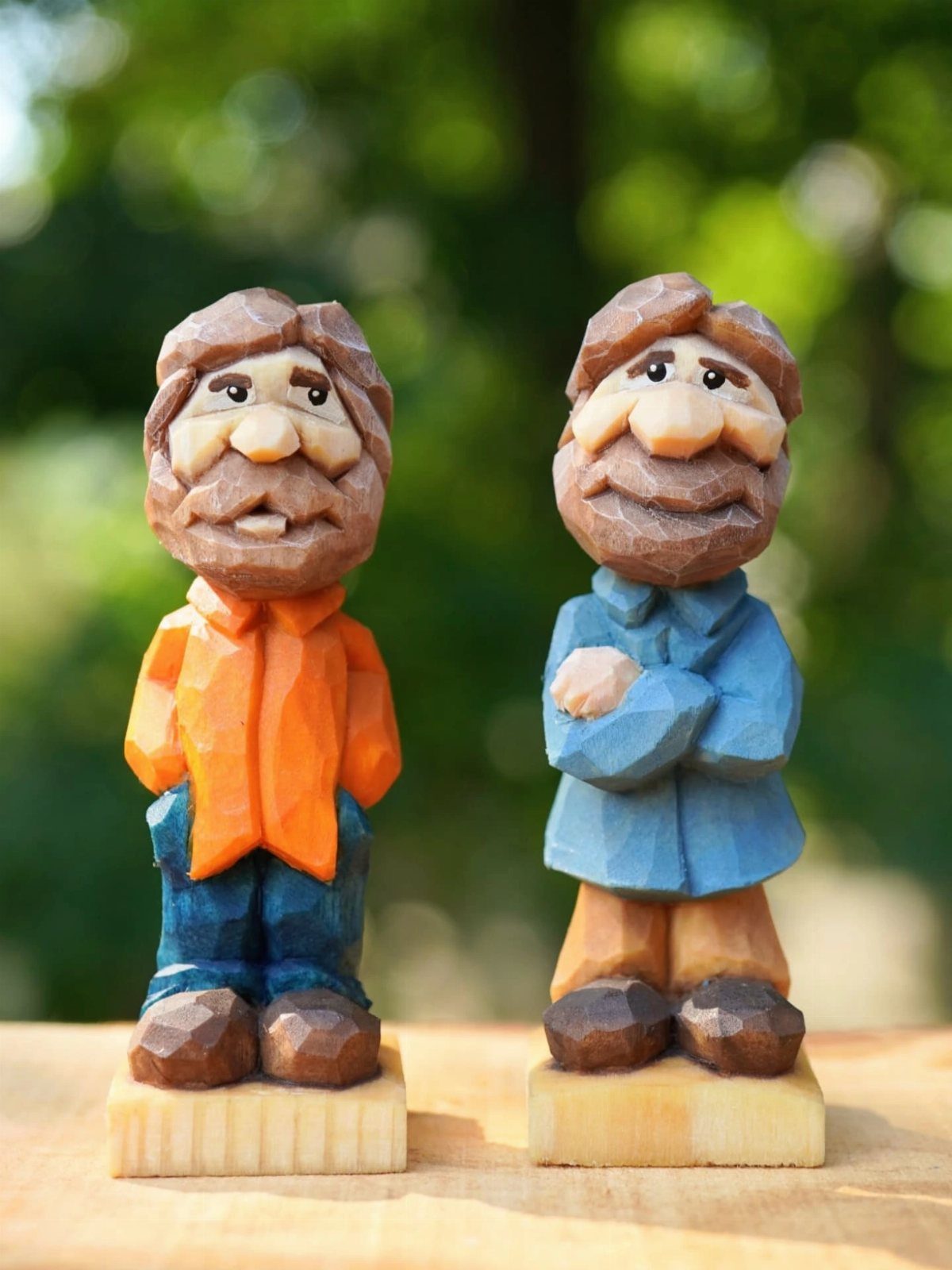 21 Small Wood Projects for Christmas You Can Make 10 Two hand-carved wooden figurines of bearded men standing on small wooden bases.