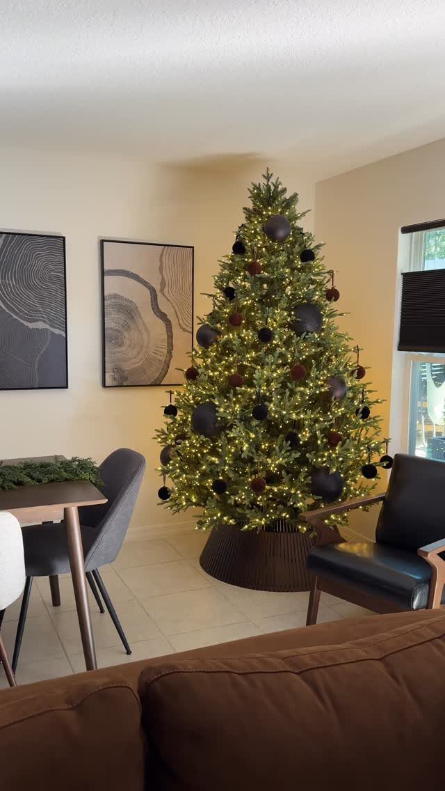 21 Small Wood Projects for Christmas You Can Make 13 Decorated Christmas tree with a dark brown wooden circular collar at its base.